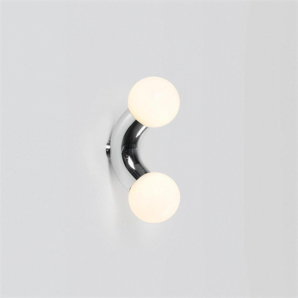 Como chrome wall light on a white wall - Hestia + Co.