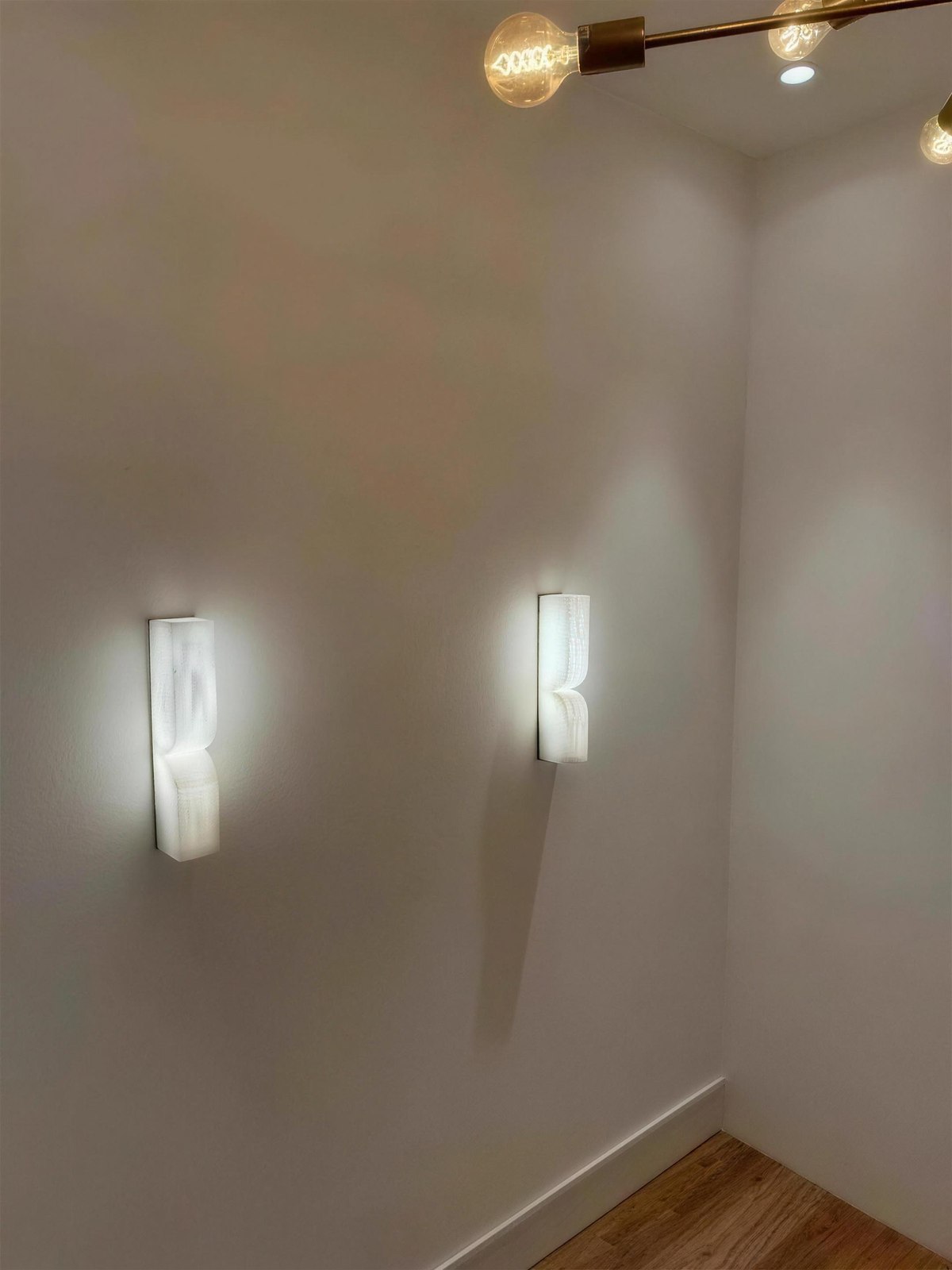 Two Ronda marble wall lights lit in a corridor - Hestia + Co.