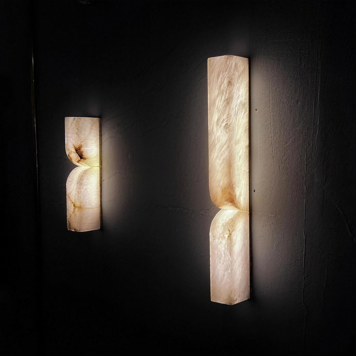 Ronda marble wall lights in 35cm and 60cm, lit on a dark wall - Hestia + Co.
