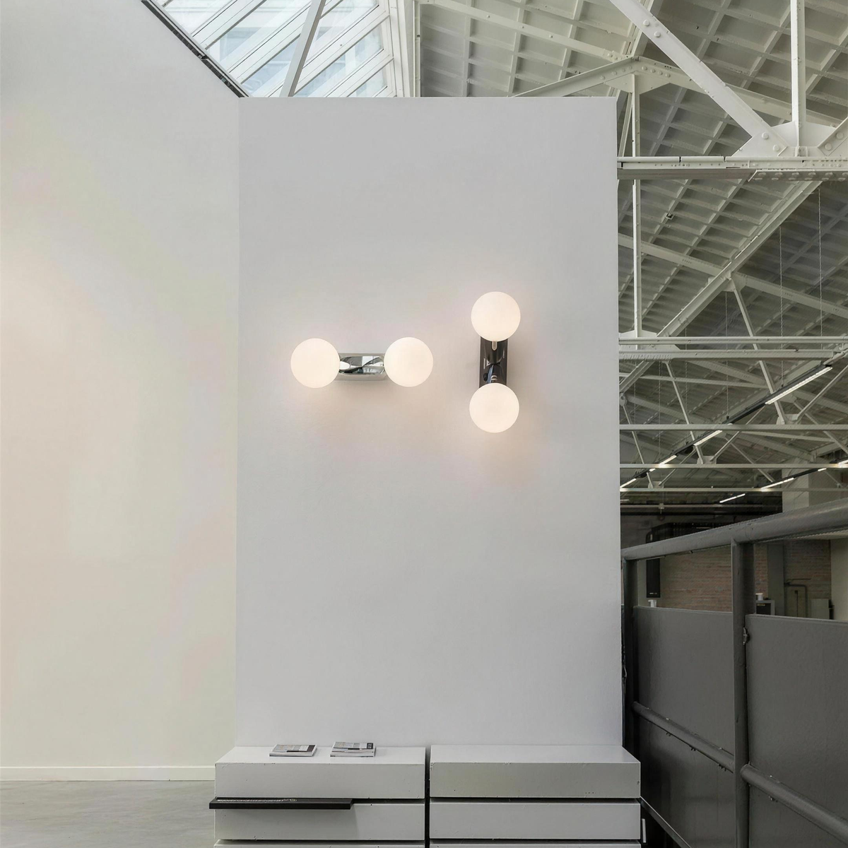 Como wall lights mounted vertically and horizontally in a white showroom - Hestia + Co.