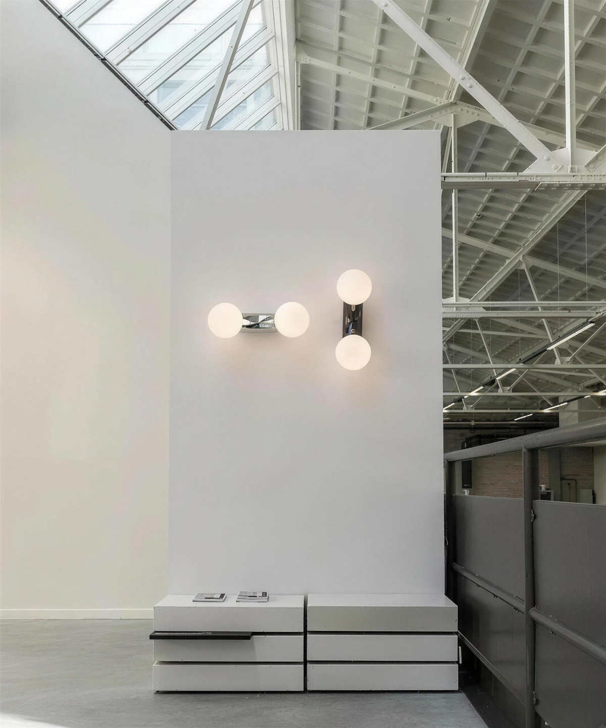 Como wall lights mounted vertically and horizontally in a white showroom - Hestia + Co.