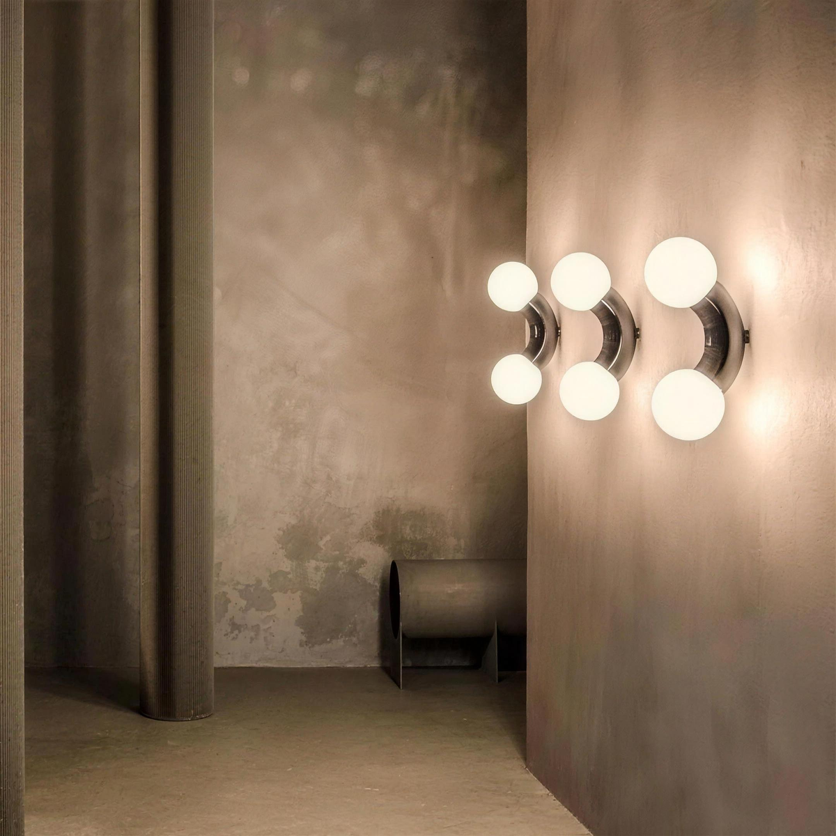 Three Como wall lights in a row on a plaster wall - Hestia + Co.