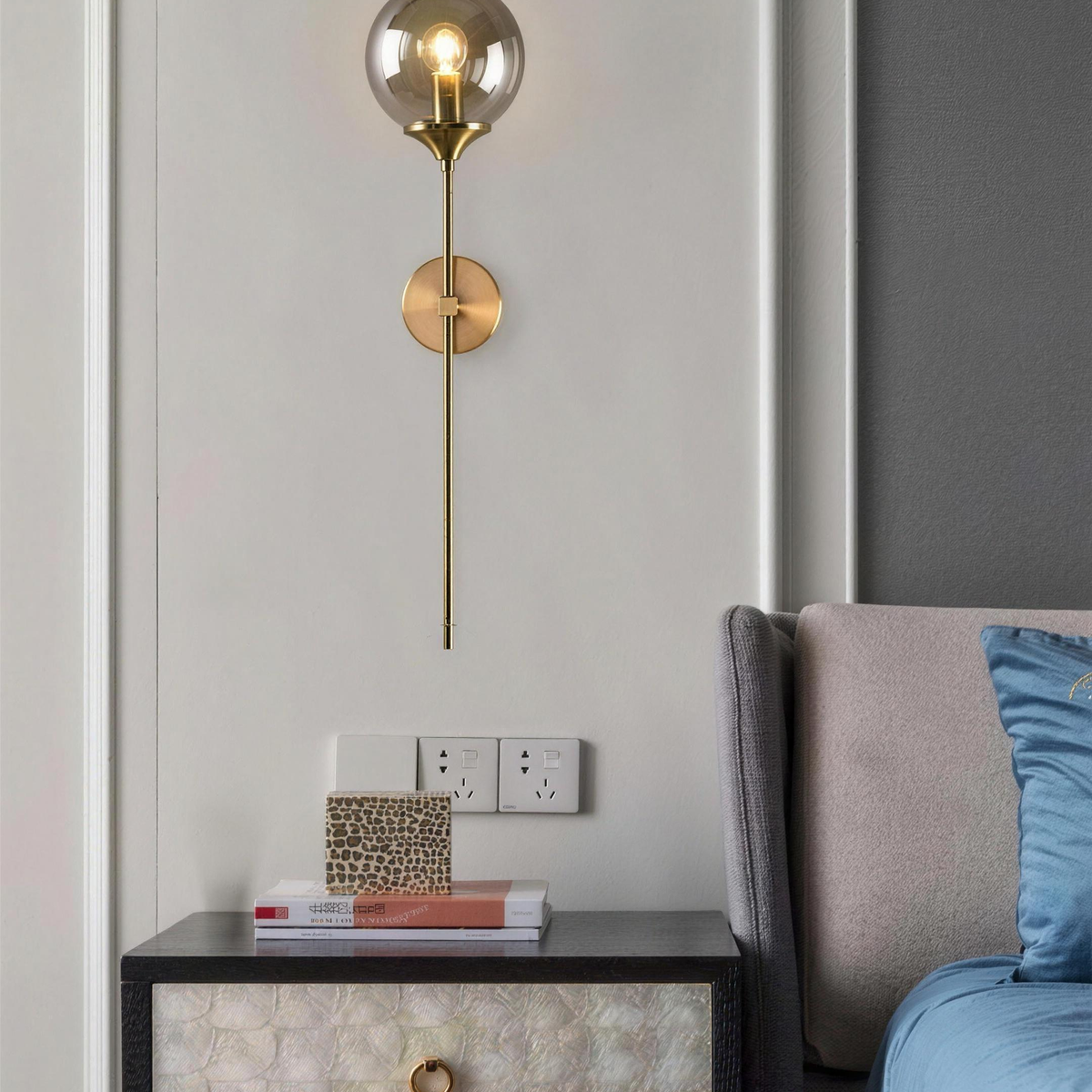 Marlow smoky grey glass wall light above a bedside cabinet - Hestia + Co.