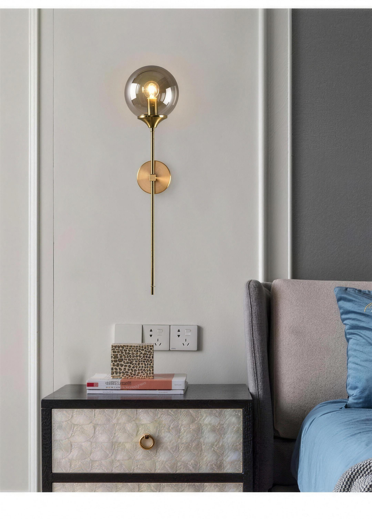 Marlow smoky grey glass wall light above a bedside cabinet - Hestia + Co.