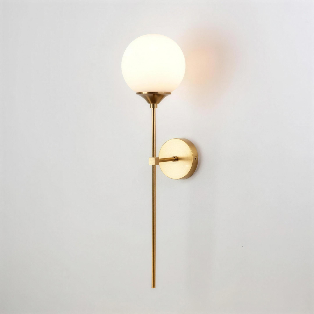 Marlow gold wall light with opal white globe - Hestia + Co.